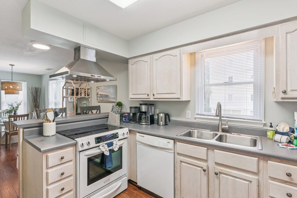 Your fully equipped kitchen invites you to prepare meals with ease. Enjoy modern appliances, ample counter space, and natural light streaming through the window—everything you need for comfortable, home-style cooking during your stay.