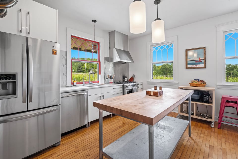 Bright modern kitchen with butcher-block island and sunny garden views