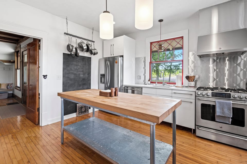 Bright modern kitchen with butcher-block island and stainless appliances