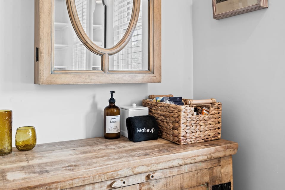Rustic vanity nook with mirror, guest essentials, and woven storage