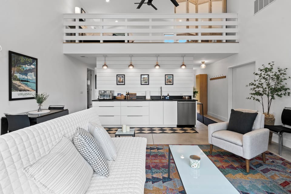 Bright loft-style living area with modern kitchen and soaring ceilings