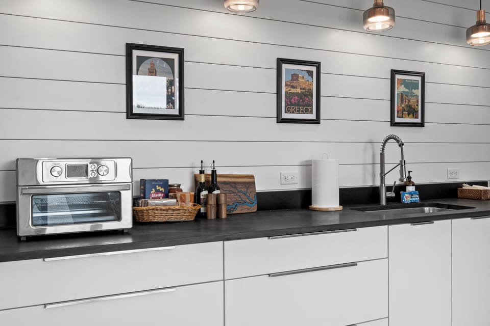 Modern kitchenette with sleek finishes, prep space, and stylish decor