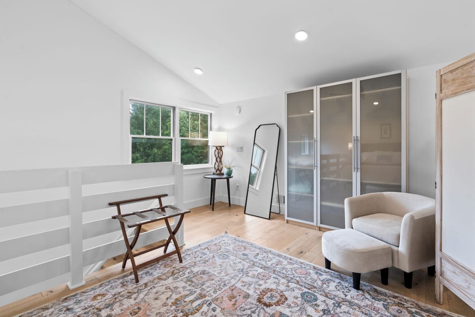 Bright, airy retreat with cozy seating, natural light, and ample storage