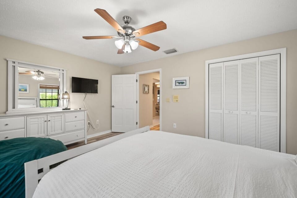 Guest bedroom with plush queen-sized bed