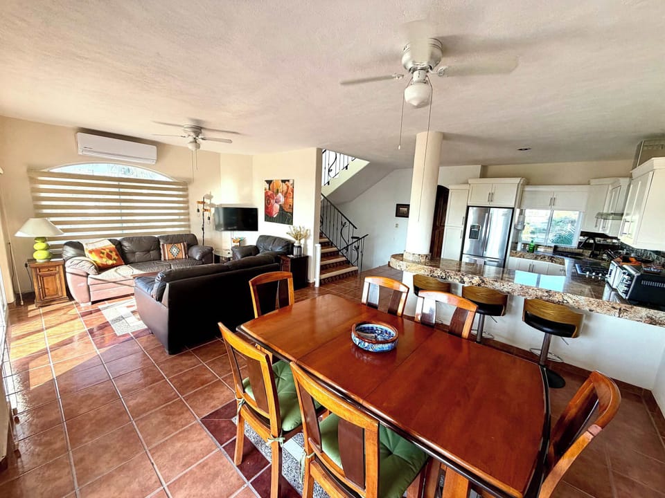 Main house dining area with view of kitchen and living room.