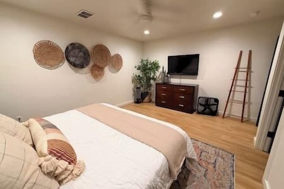 Bedroom 3 from the doorway — brick accent wall and warm wood tones