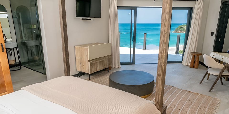 Wake to ocean blues from bed, steps from terrace.