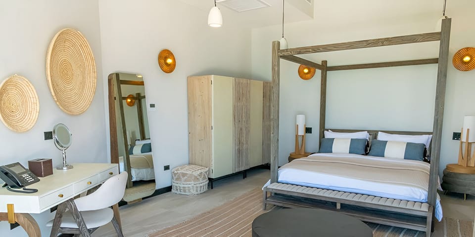Sink into crisp linens in a serene, sunlit canopy bed.