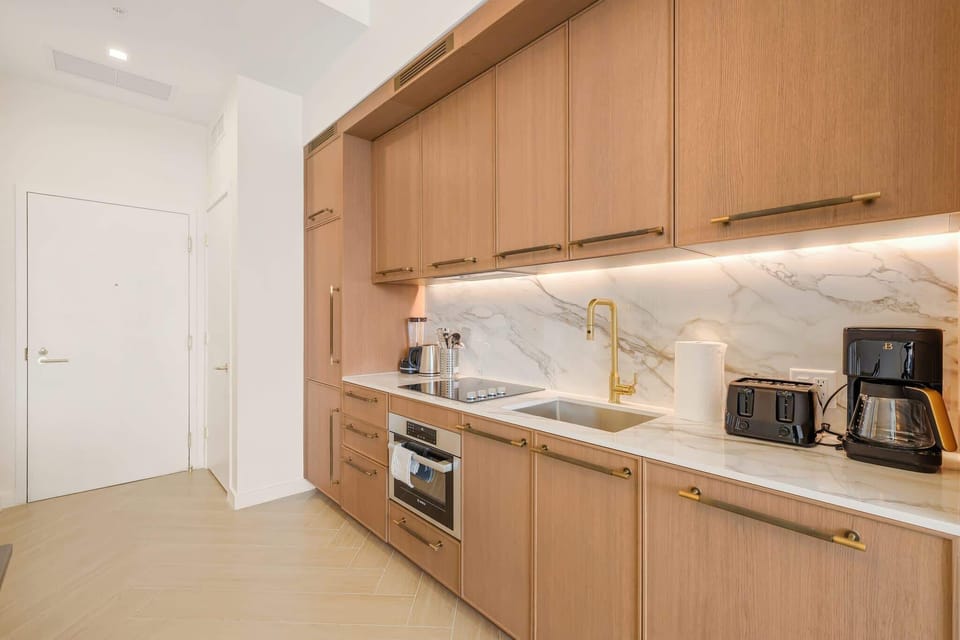 Sleek and modern kitchen with high-end appliances and elegant finishes, perfect for cooking and entertaining.