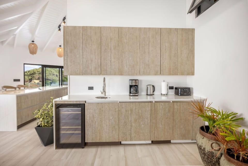 Cook with ease in a sleek, sunlit designer kitchen.