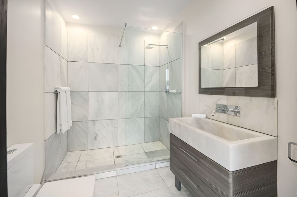Refresh in a bright, modern walk-in rain-style shower.