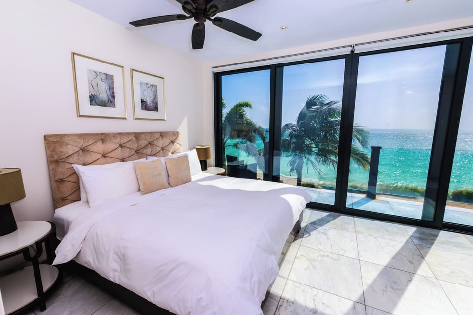 Wake to ocean panoramas from bed through dramatic glass doors.