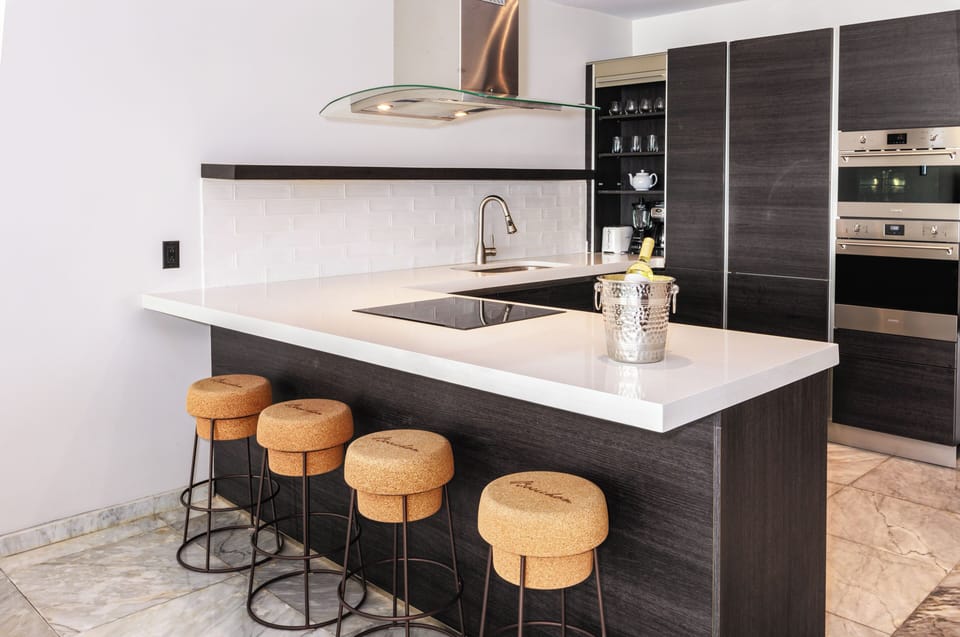 Gather for cocktails around the polished island and stools.