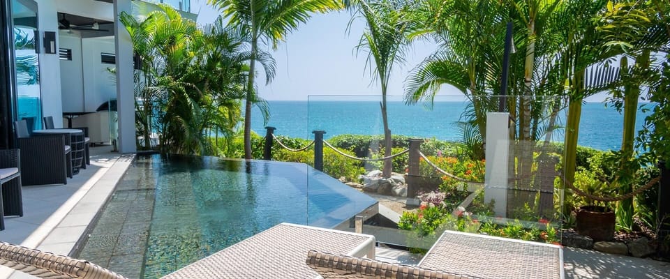 Sip and swim beside a shimmering pool overlooking the ocean.
