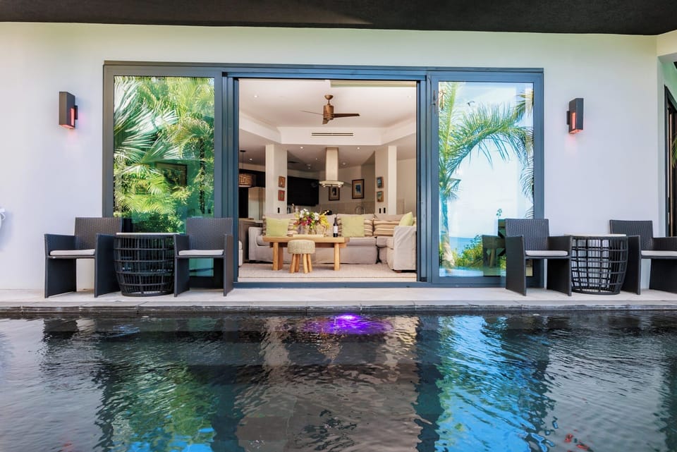 Dine indoors while the pool sparkles just beyond the doors.