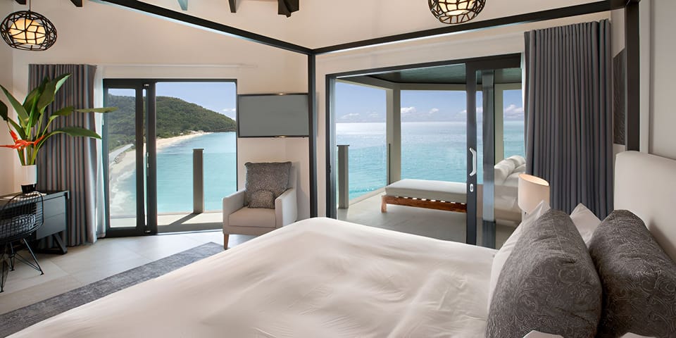 Wake to panoramic sea views from crisp, cloud-soft bedding.