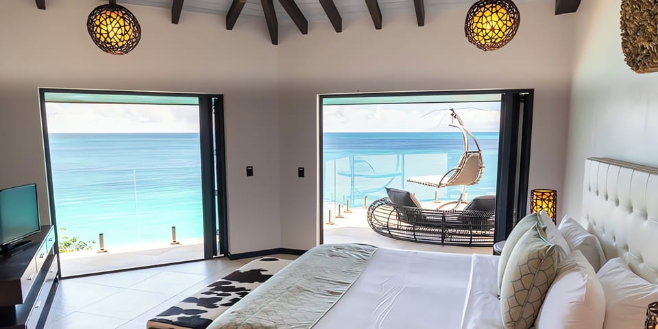 Wake up to endless turquoise views from your plush bed.