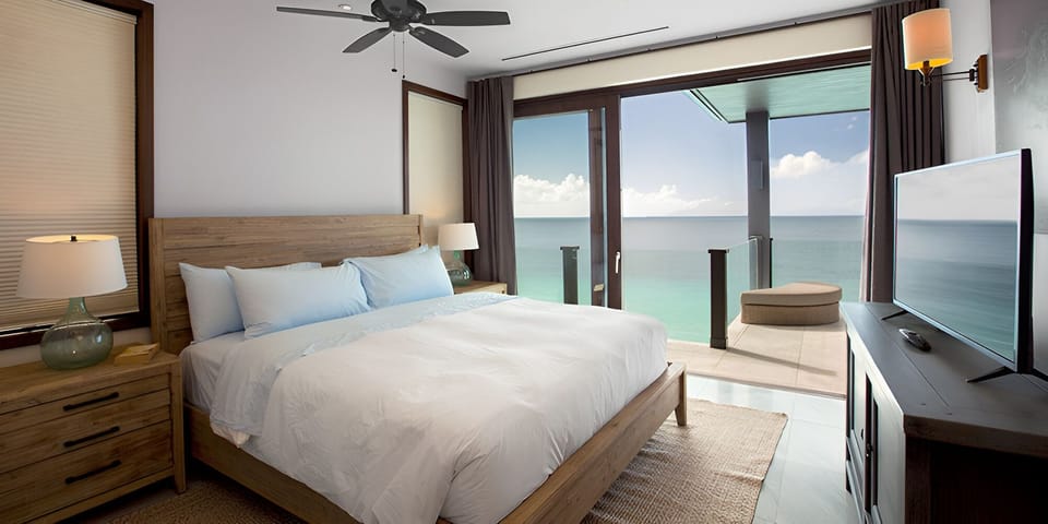 Drift off with balcony breezes and calming turquoise horizons.