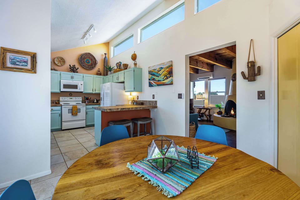 Look straight through from the table to the kitchen and the fireplace beyond