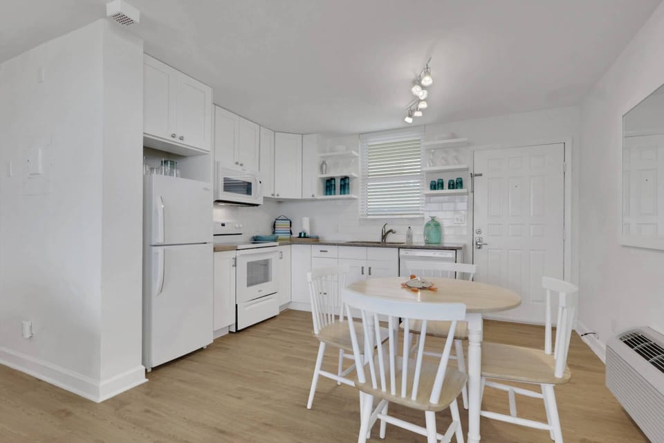 The updated kitchen and dining area offer a welcoming space for everything from a quick breakfast before the beach to a relaxed dinner at home.