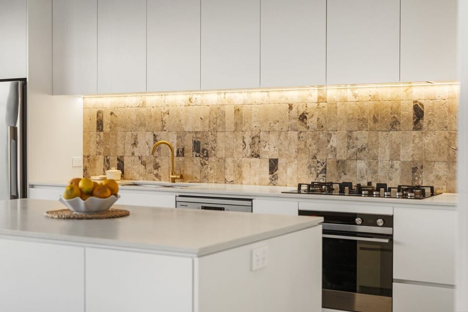 Sleek designer kitchen with stone benchtops and premium finishes