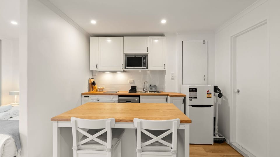 Modern kitchen with island seating and full-size appliances.