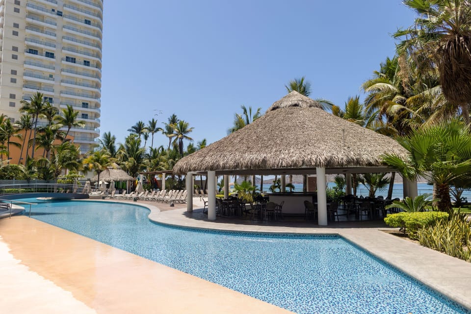 Outdoor pool, open 7:00 AM to 10:00 PM, pool umbrellas, sun loungers