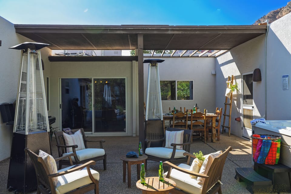 The private courtyard is set for open-air meals, relaxed drinks, and a soak in the hot tub.