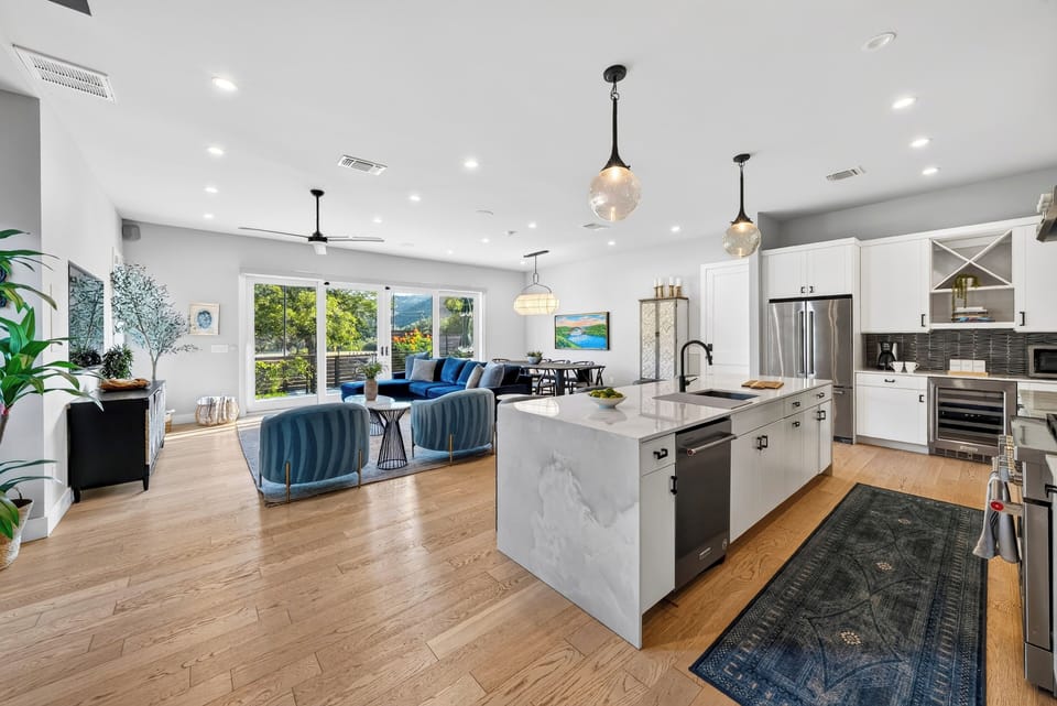 Waterfall marble island anchors the open kitchen