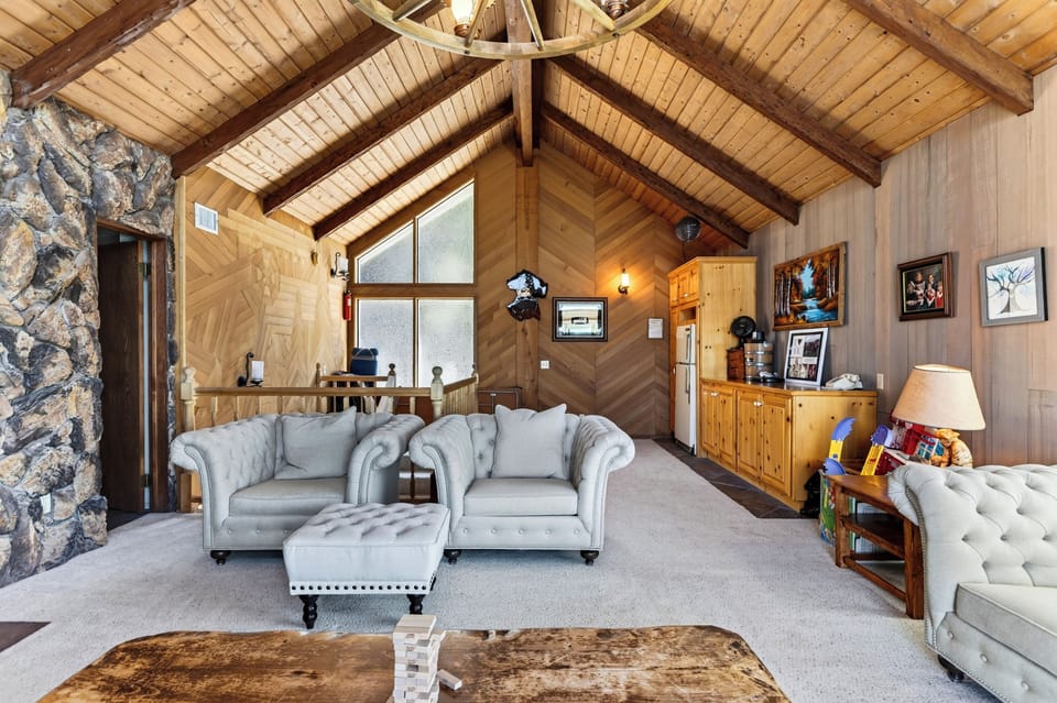 Bright living room space with comfortable sofas and wooden accents.