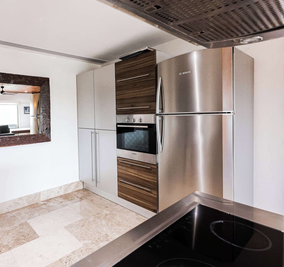 Modern kitchen with stainless appliances.