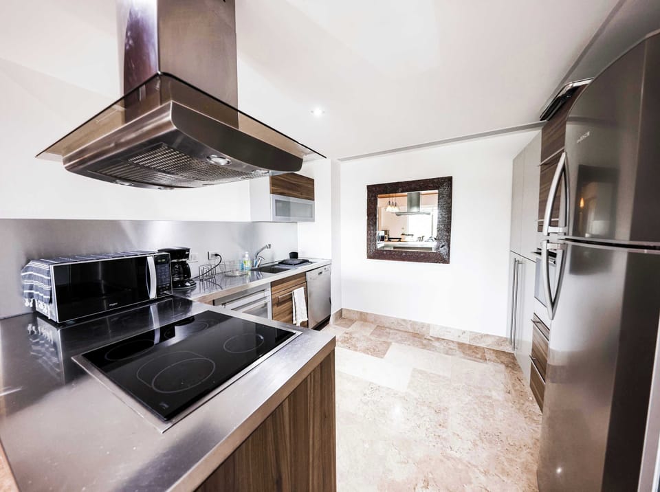 Modern kitchen with stainless appliances.