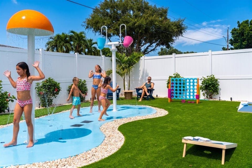 Heated splash pad with yard games adjacent