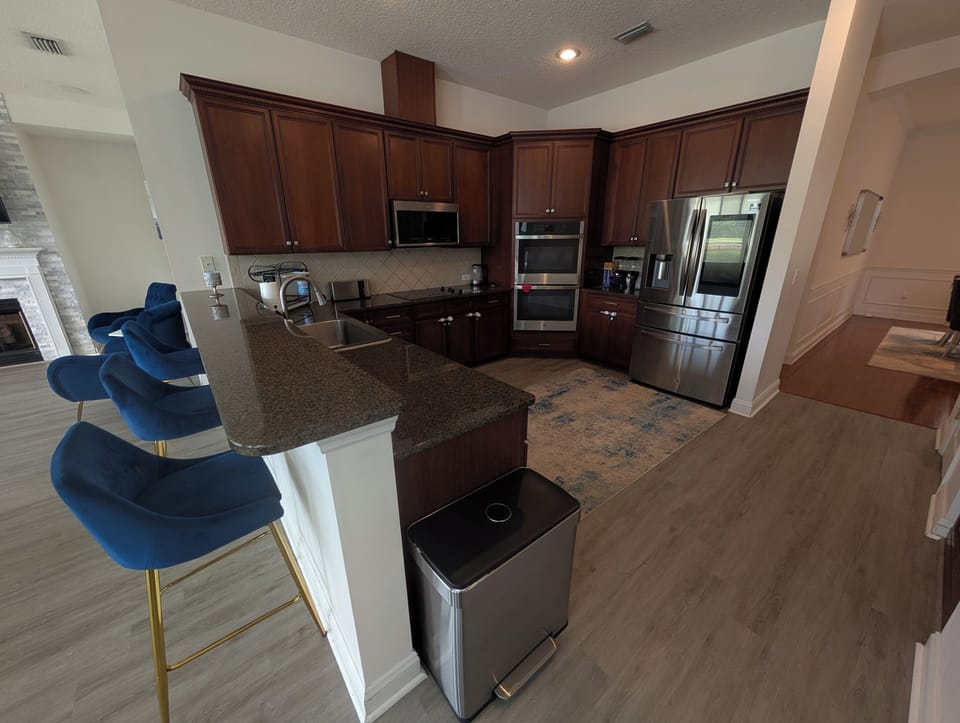 Spacious kitchen with granite countertops, stainless steel appliances, and plenty of room for preparing meals.