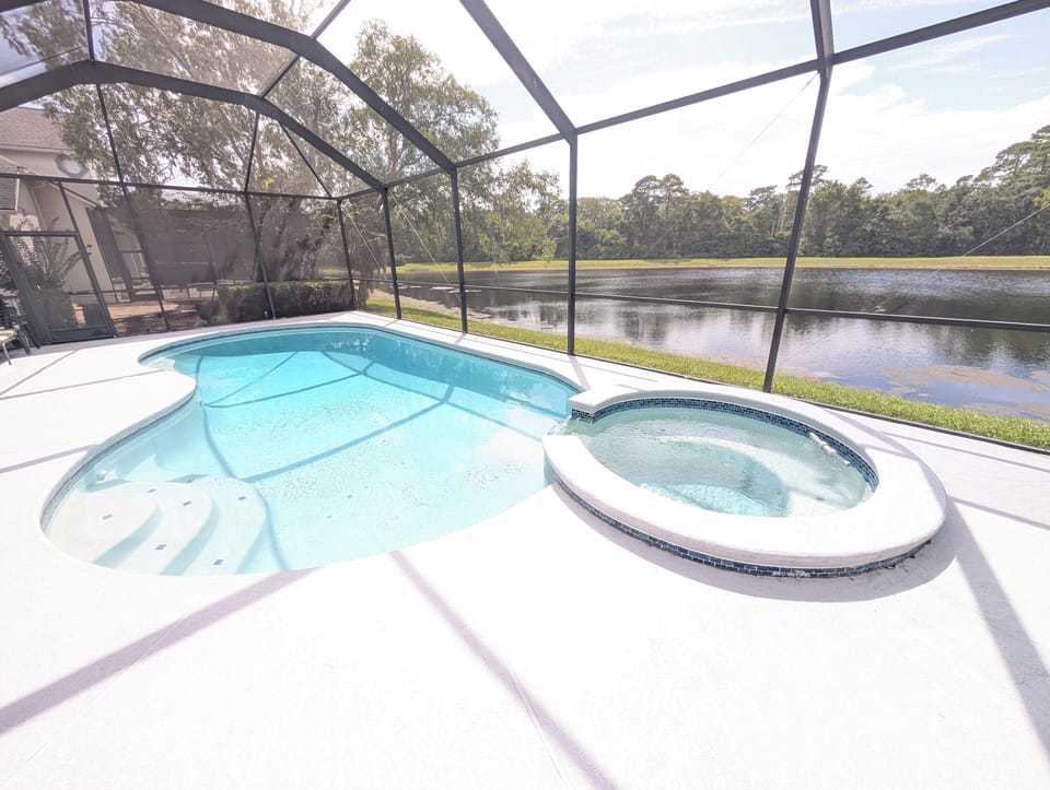 Private screened-in pool overlooking the peaceful pond — an ideal place to cool off and enjoy the Florida sunshine.