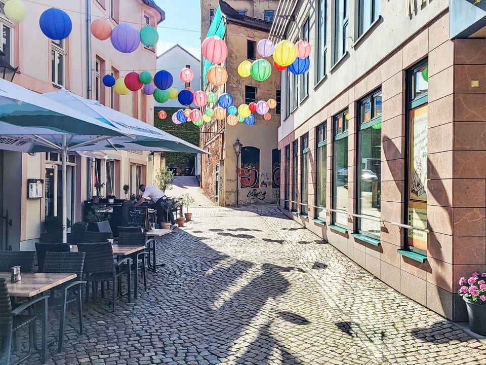 Town, Mixed-Use, Cobblestone, Outdoor Table, Sidewalk, Restaurant, Chair, Outdoor Furniture, Alley