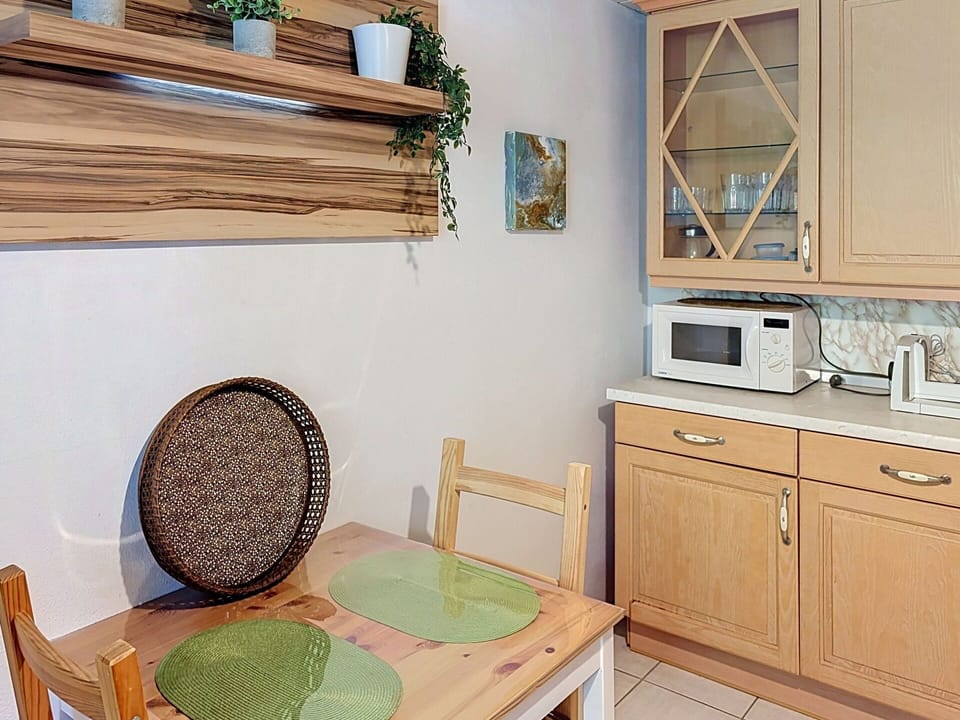 Furniture, Interior Design, Wood, Flooring, Cabinetry, Kitchen, Room, Countertop, Floor, Lighting