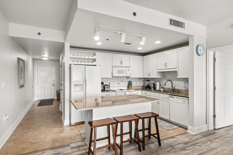 Enjoy preparing meals in your bright, well-equipped kitchen with granite counters, a breakfast bar, and modern appliances—all within an open, airy layout.