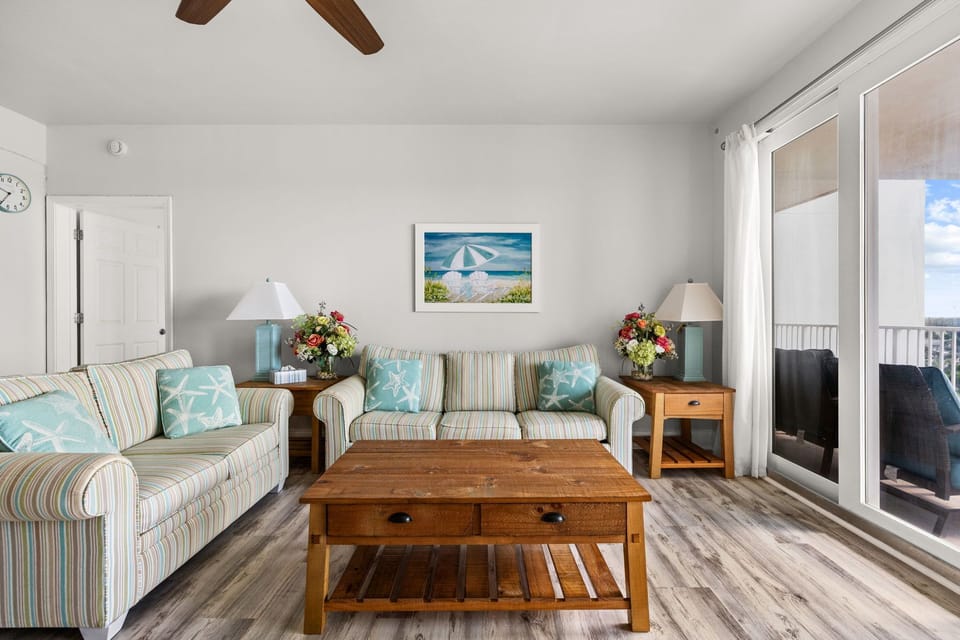Sink into the plush sofas and let the coastal vibes wash over you. Turquoise accents and warm wood tones create your perfect home base, just steps from your private balcony.