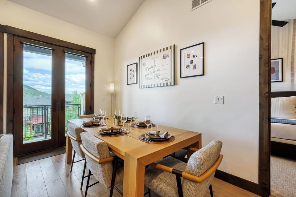 Gather around this welcoming dining space where your group can share meals and stories together. The warm wood tones and mountain views create the perfect backdrop for your vacation memories.