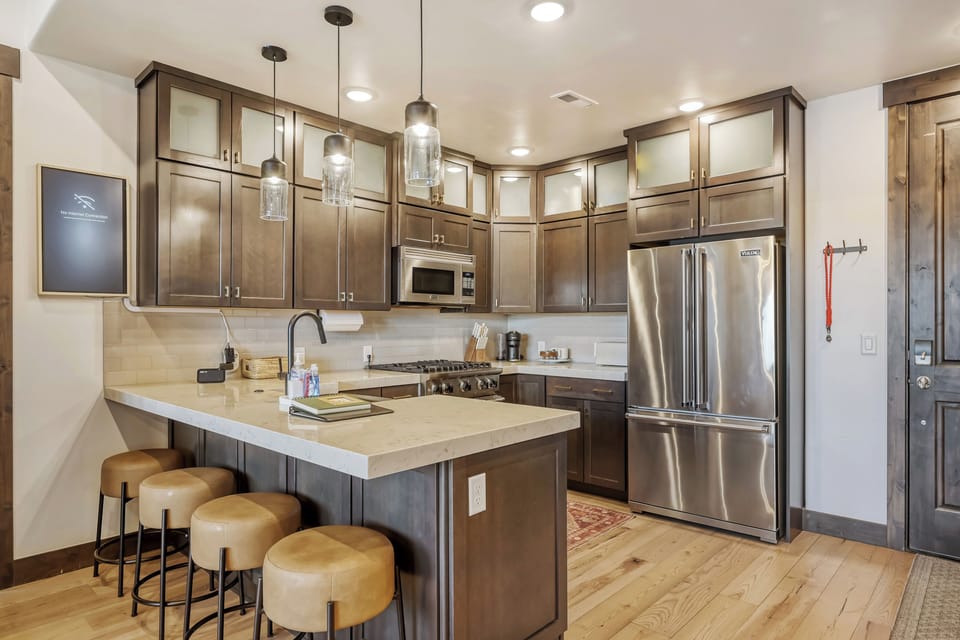 Step into your stylish kitchen with sleek stainless appliances, spacious countertops, and a welcoming breakfast bar—perfect for morning coffee or preparing home-cooked meals during your stay.