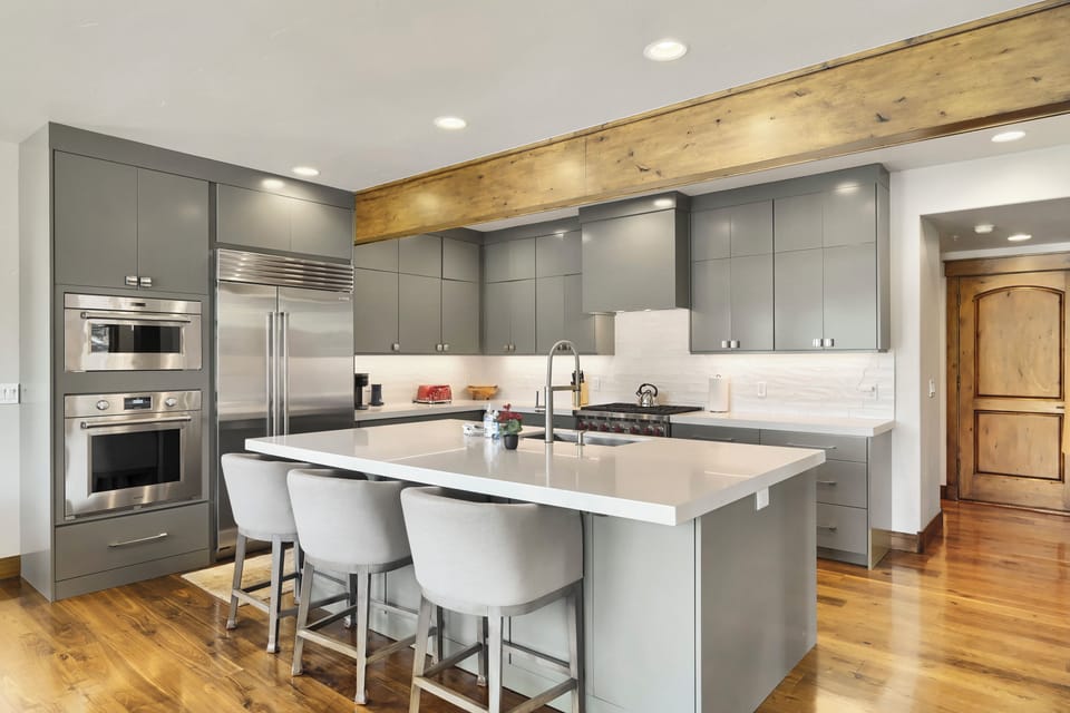 Your gourmet kitchen awaits with sleek modern cabinetry, stainless steel appliances, and a spacious island perfect for meal prep or casual dining with friends and family.