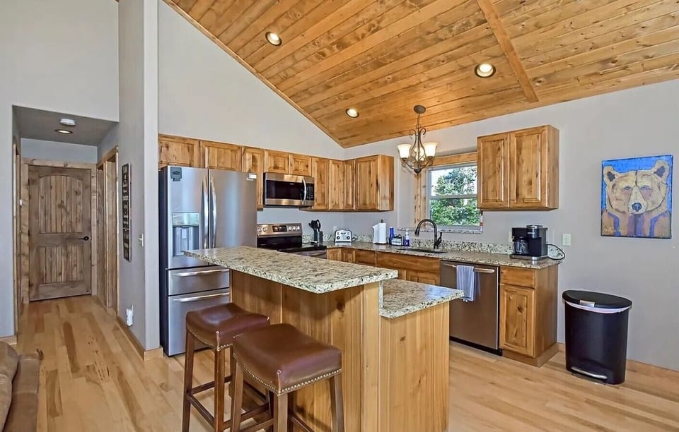 The cozy kitchen island with seating for two is perfect for morning coffee or keeping the chef company.