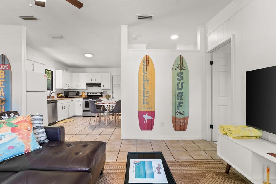 Open-concept kitchen and dining area with coastal charm and beachy accents.