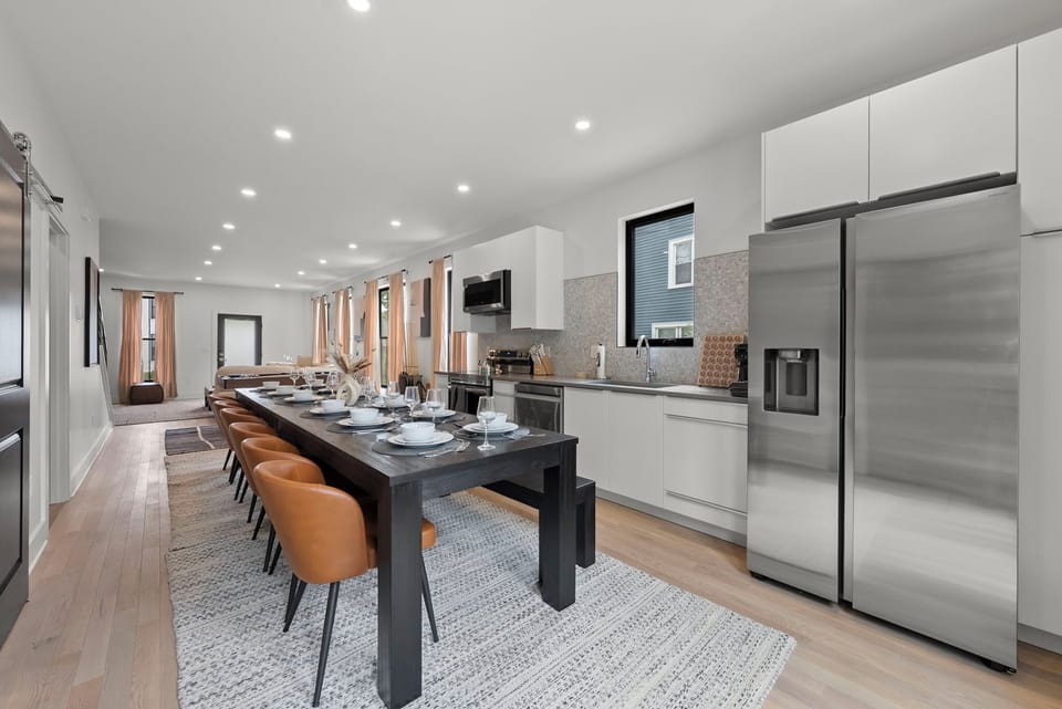 [Dining - Main Floor | Spacious modern kitchen with large dining table fits entire family comfortably]