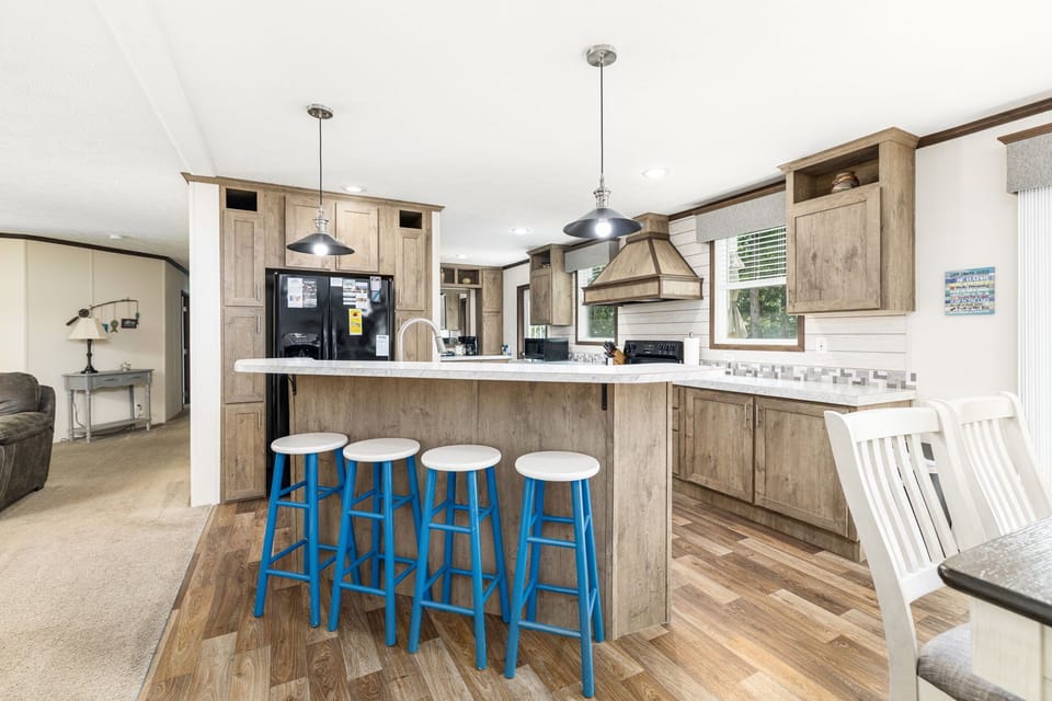 Bright and stylish space with chic bar stools and modern appliances awaits!