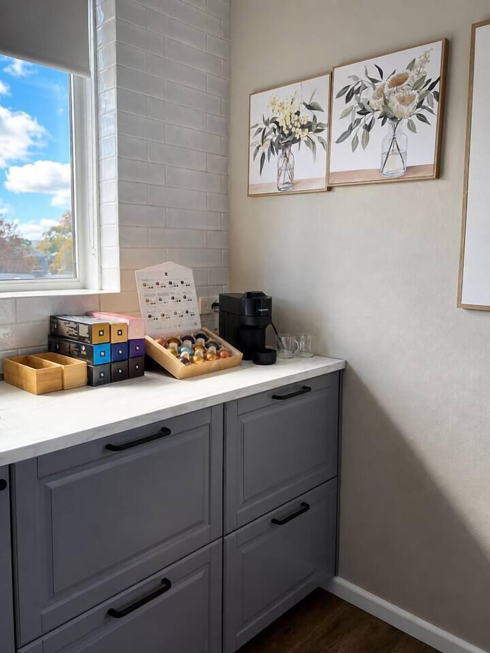 A bright corner of the kitchen with breakfast bar, kettle, and pantry storage — ready for guests to start the day with a fresh brew.