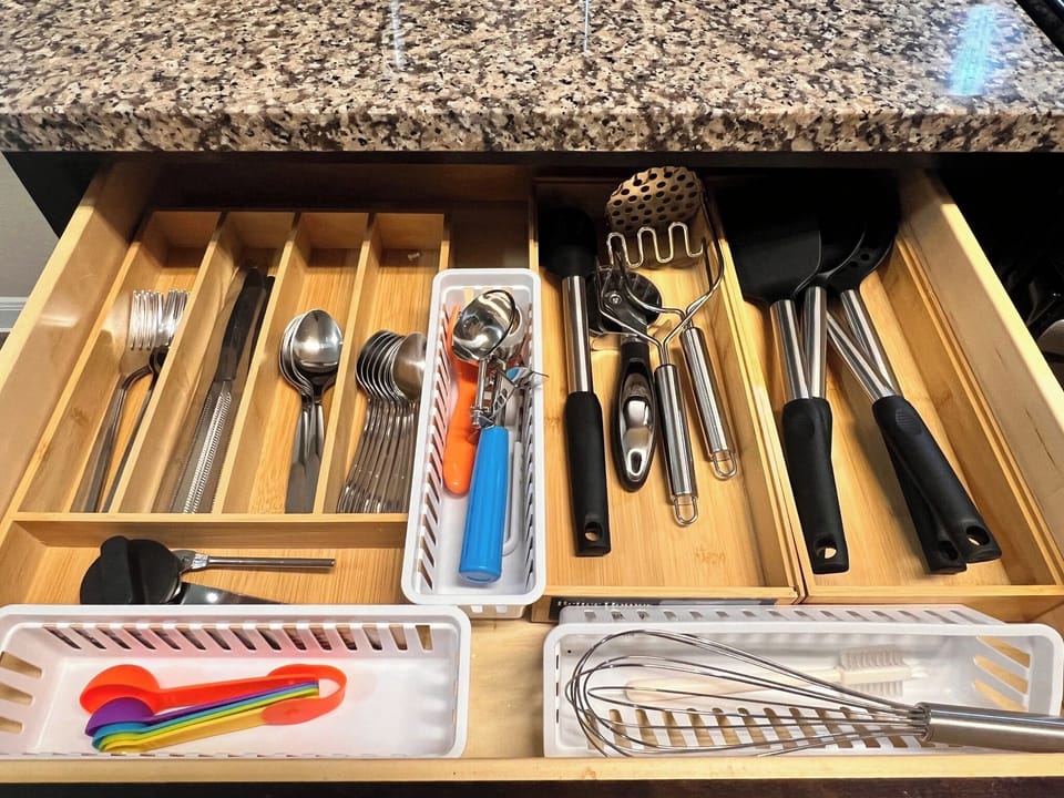 Stocked kitchen drawers provide utensils and cooking tools for preparing meals throughout longer assignments. A home-away-from-home convenience for construction crews, corporate travelers and insurance stays in Kyle.