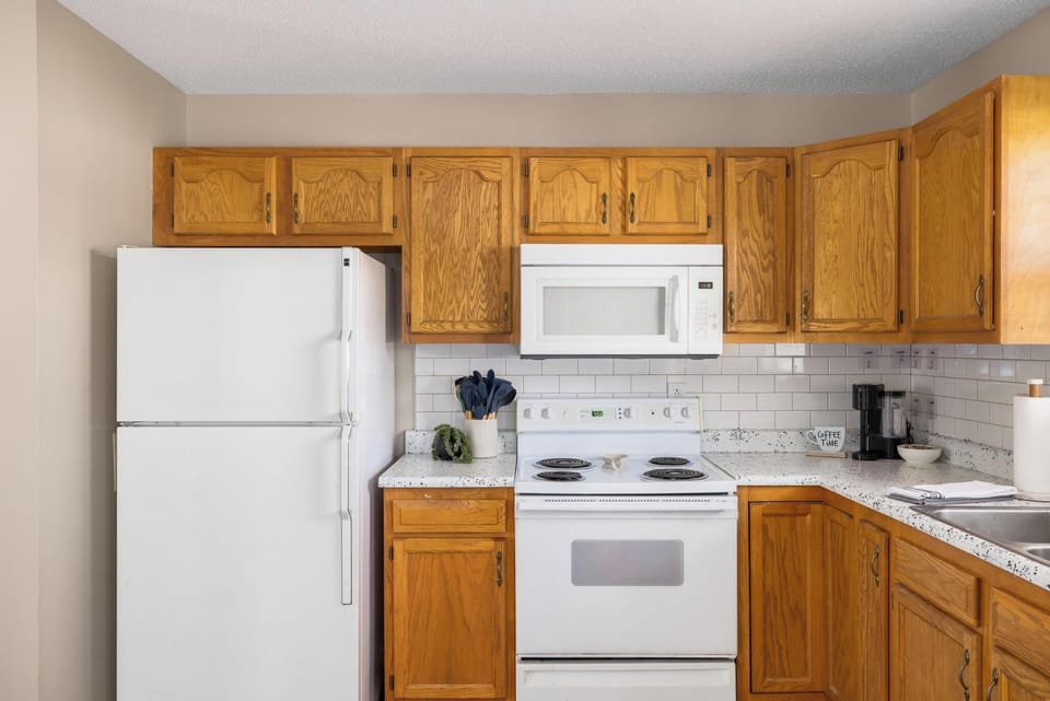 Bright kitchen with ample storage, coffee station, and clean classic finishes