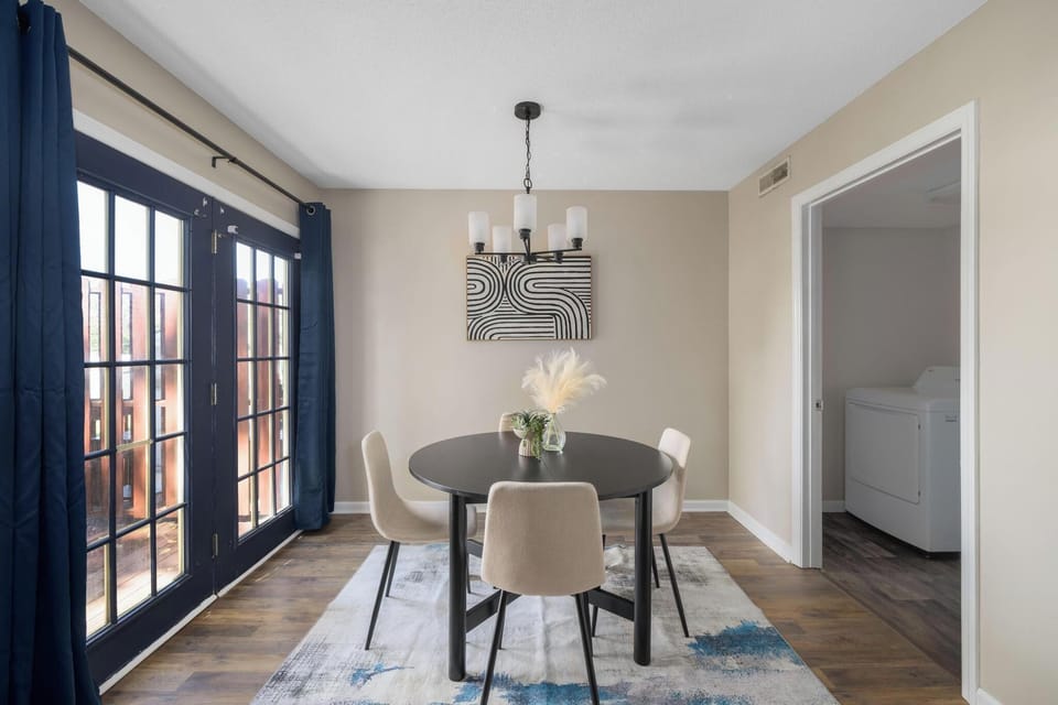 Bright dining nook with French doors, stylish decor, and in-unit laundry